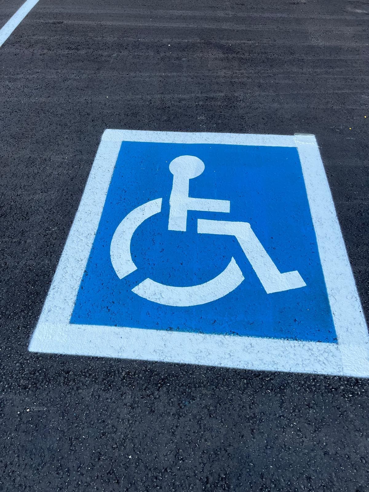 Accessible parking symbol and markings on asphalt