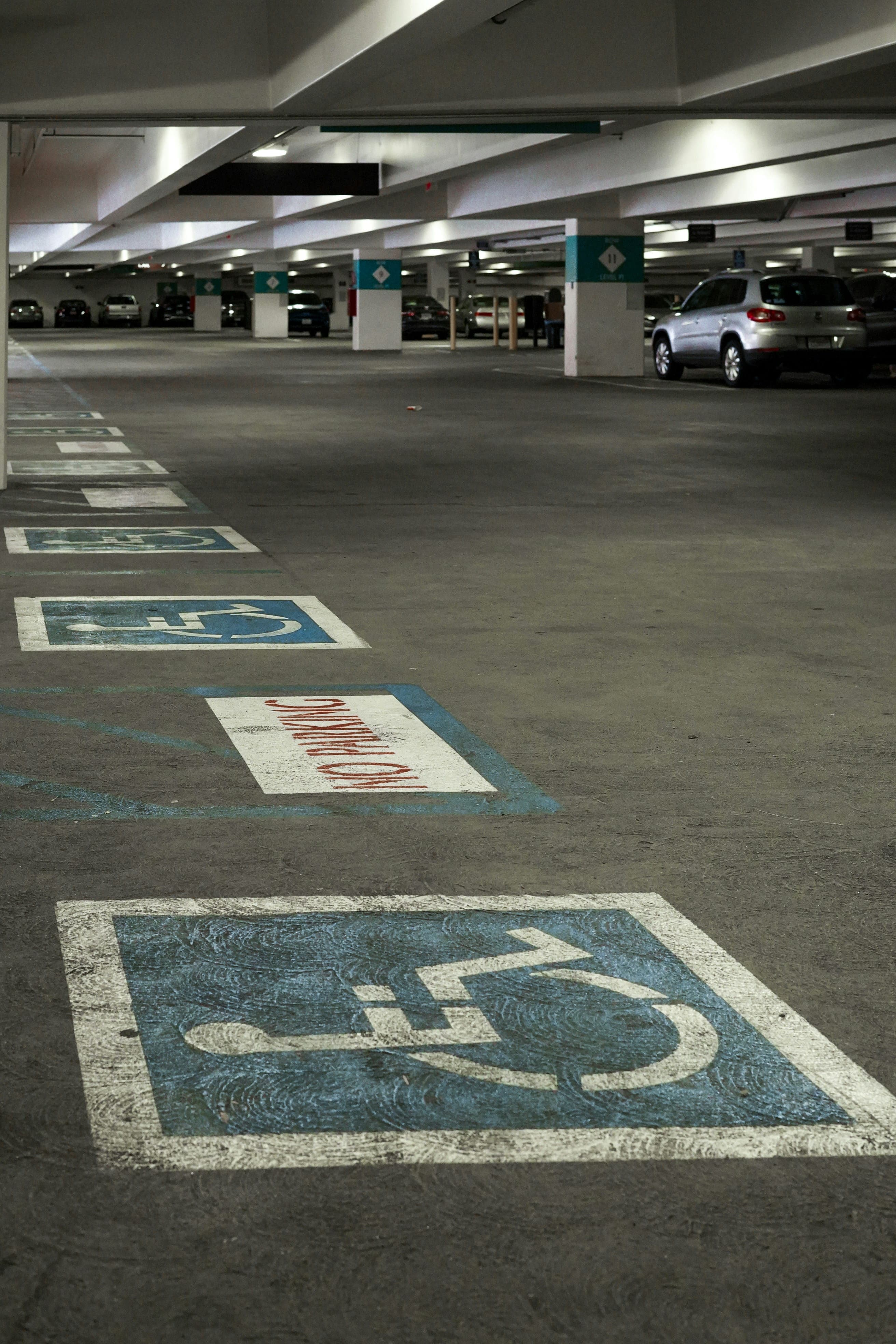 Accessible parking symbols and no-parking markings in an indoor garage
